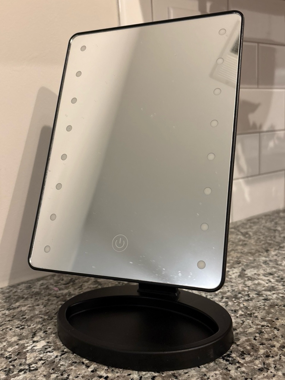 Conair adjustable tilt LED mirror with storage. Needs triple A batteries.